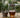 Tea strained into a glass through a steel strainer, with a steel bowl on wood